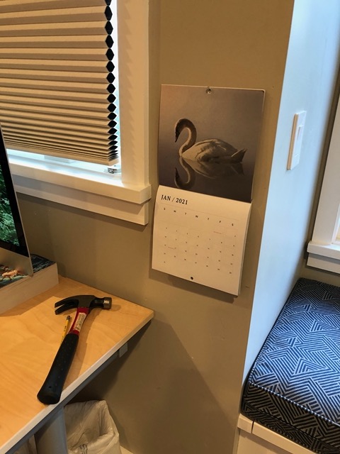 Nailing Owen's calendar to the wall, finally!