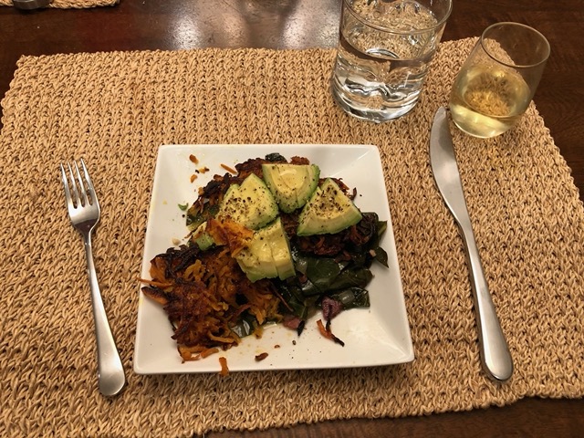 Sweet potato pancakes on kale with avocado