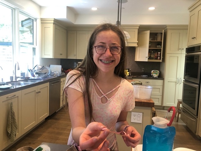 Ellie back home (phew!) happily showing us a paper bead she made