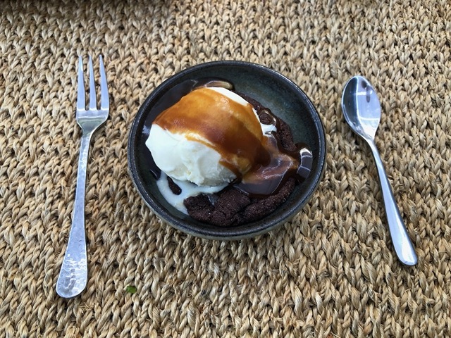 Homemade vanilla ice cream with caramel sauce on warm chocolate cookie