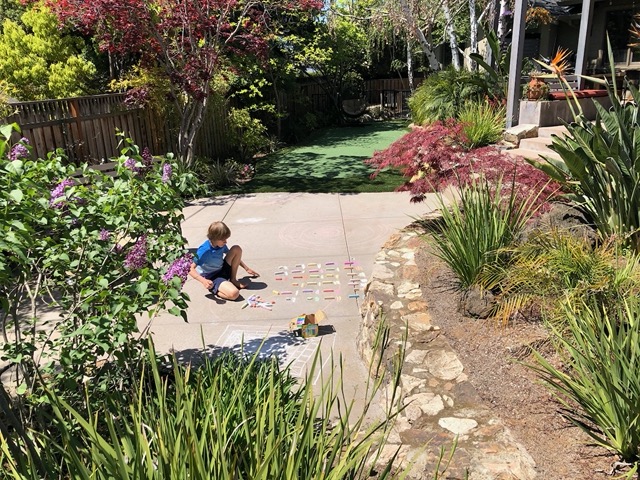 Owen testing each piece of sidewalk chalk