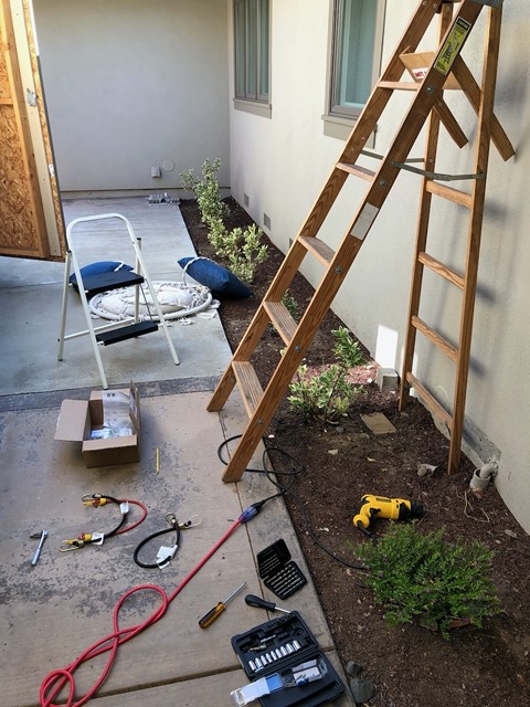 Drilling holes for Lela's sun shade