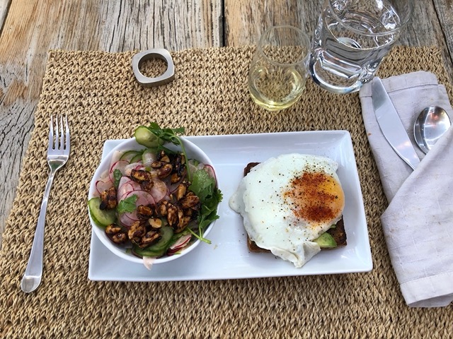 Cucumber radish salad with roasted nuts, fried egg on rye with avocado