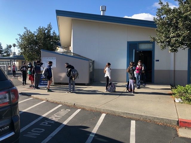 Owen's class lining up for school, masked and 6 feet apart