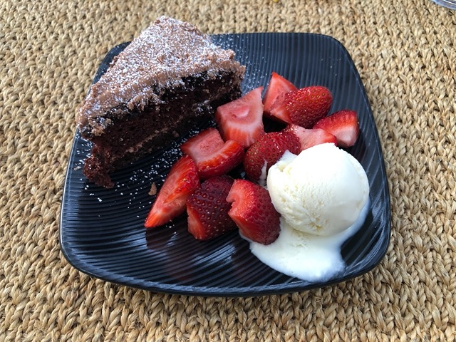 Delicious birthday dessert: chocolate cake, strawberries, vanilla ice cream