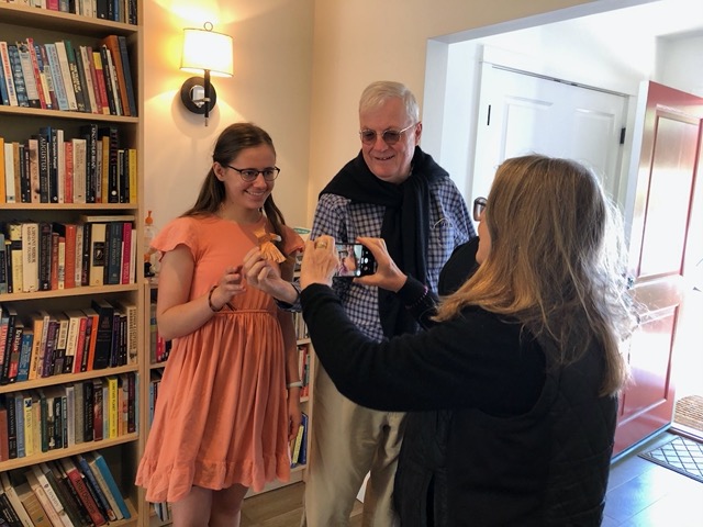 Lela giving them an origami eagle, which is now on their mantlepiece at home