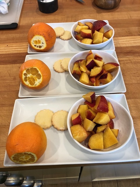 Transitional fruit plate:  navel orange, stonefruit, and lemon cookies