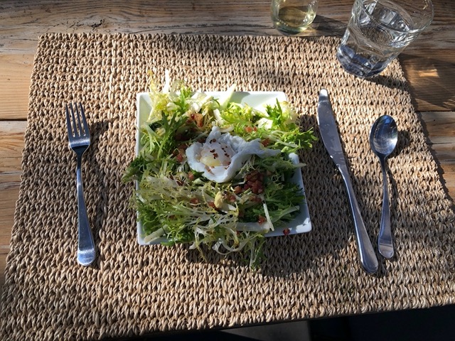 Frisee salad with lardons and poached egg
