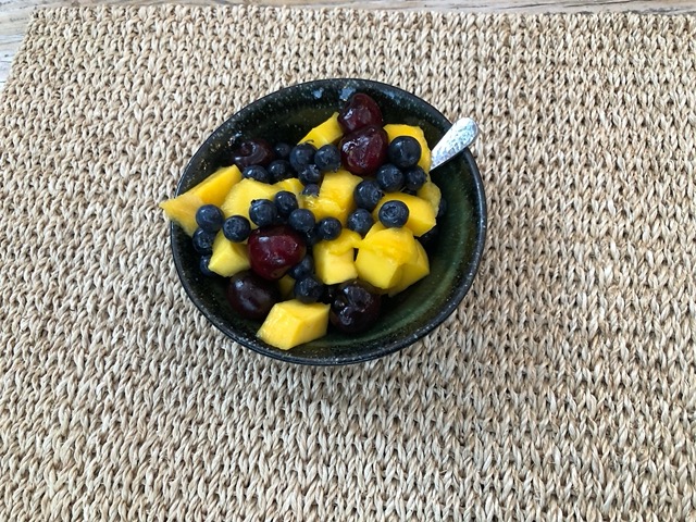 Fruit salad with blueberries, cherries, and mango