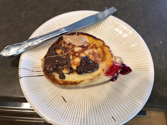 Pancake with nutella, hazelnut spread, and sour cherry jam, and maple syrup!