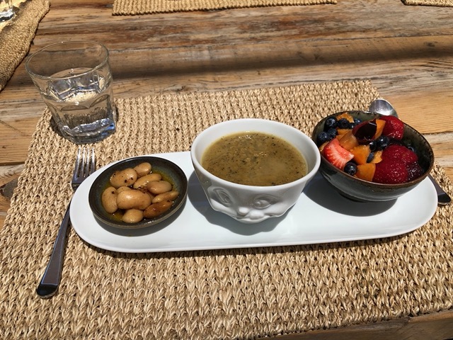Lunch of cascabel beans, grilled zucchini soup, and fruit salad