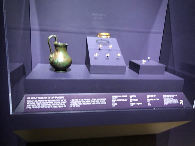 These were found with her: a bronze jug, purse, a basket of coins and jewelry