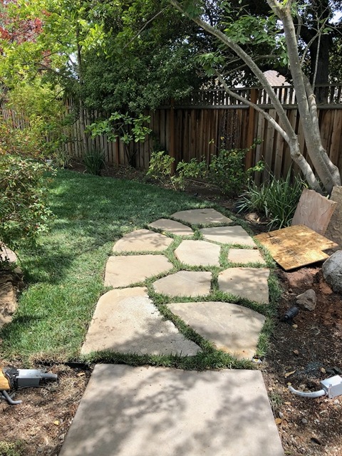 Flagstones at the far end of the new sod