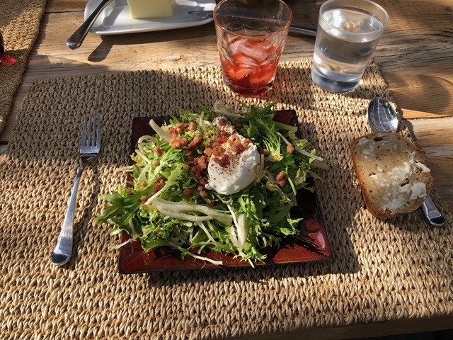 Frisee salad with lardons, poached egg, and sourdough