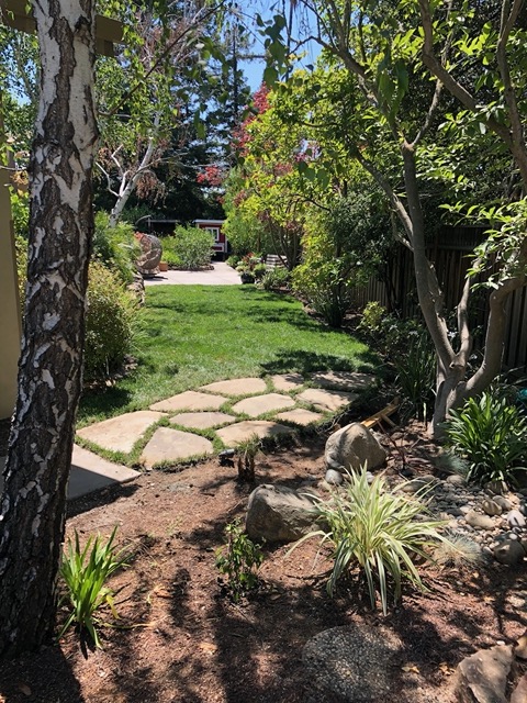 View of the flagstones and lawn from the far side