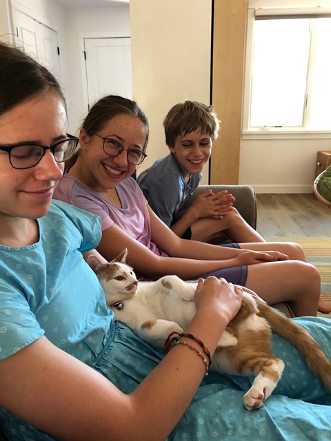 The kids on the couch for the ceremony, with cat