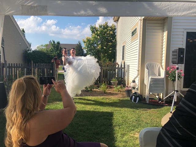 Ian carrying his new wife into the backyard