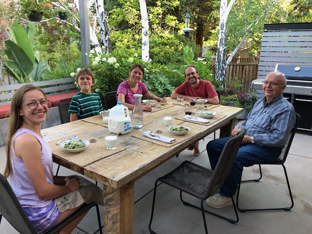 The family with Grandpa Mark at dinner on the patio