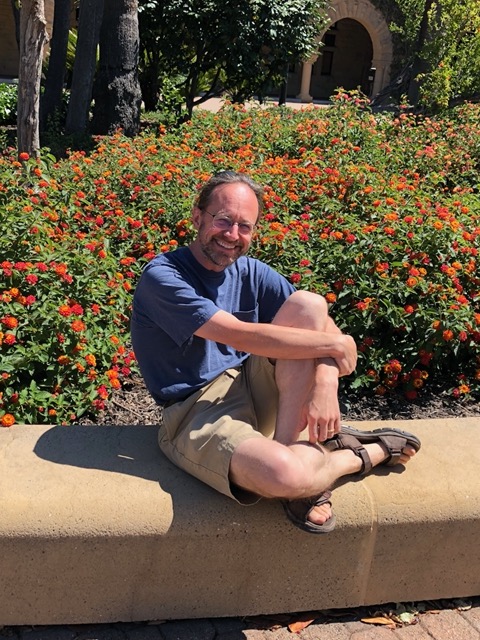 Mike on the planter where he sat in 1993, spring of Freshman year. Same pose