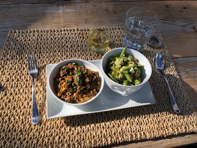 Spiced lamb on eggplant, asparagus salad with avocado, egg, and nuts.