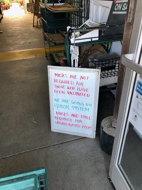 Evolving mask signs.  This is at the garden store