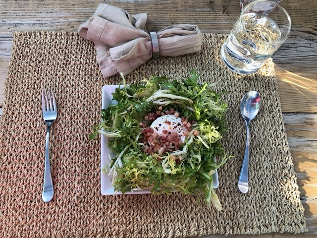 Frisee salad with poached egg and lardons