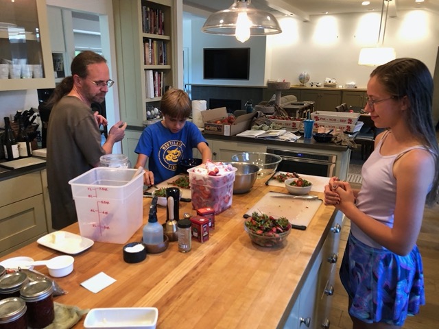 The kids helping me process more strawerries (hull and macerate in sugar)