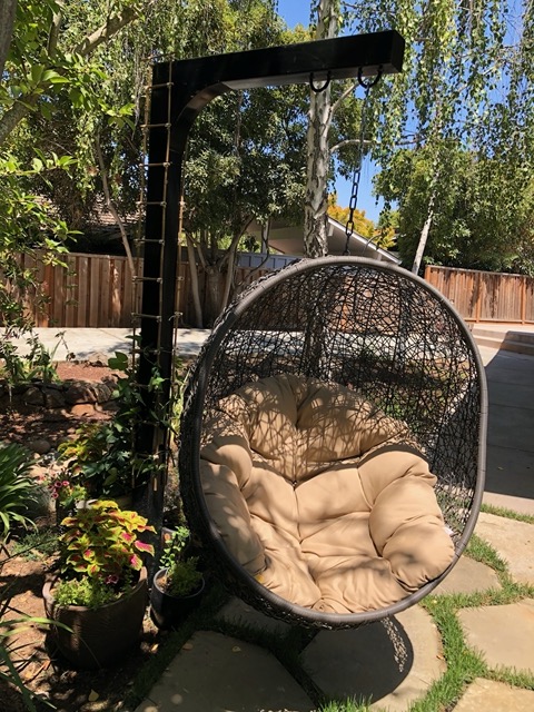 The hanging chair area, now with the new trellis!