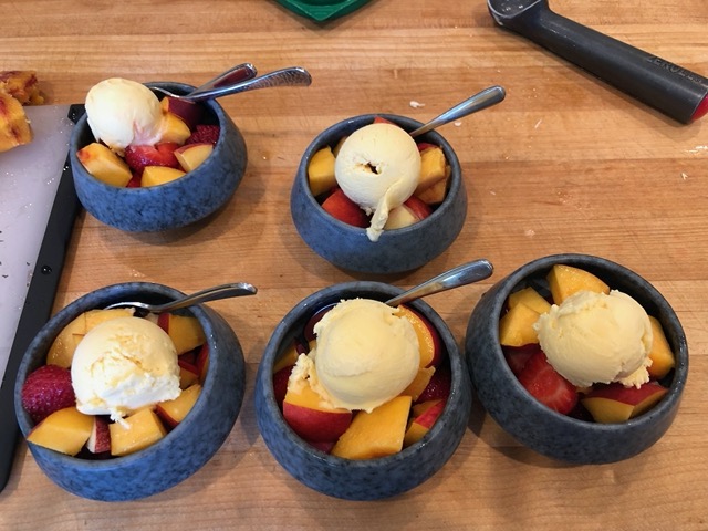 Summer dessert of stonefruit and ice cream