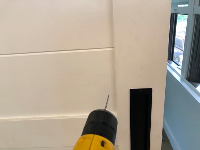 Getting ready to drill a pilot hole for the latch on the barn door