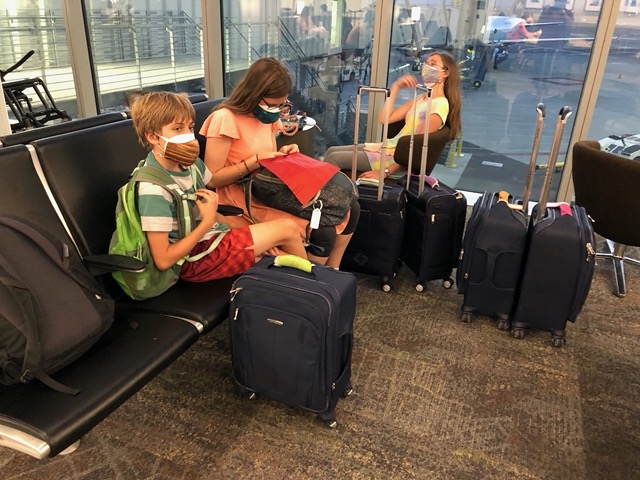 Waiting.  Double masks, Lela's folding a napkin