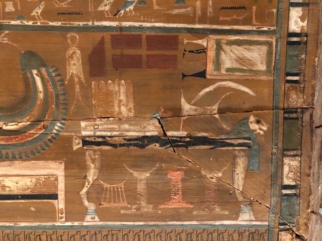 Closeup of a bed, with headrests underneath.  They painted everything he might need