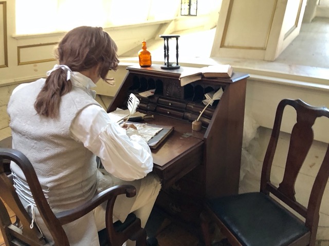 Inside the ship, model of the captain writing in his journal about the Tea Party