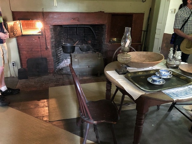 With hearth and cooking pots on a rack