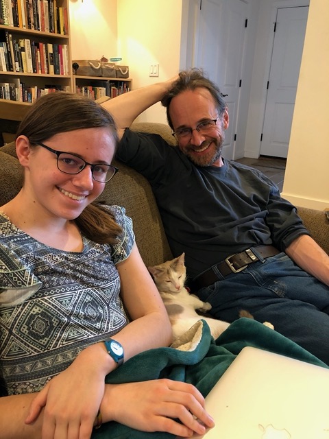 Curled up between Mike and Lela. Relaxed between two humans