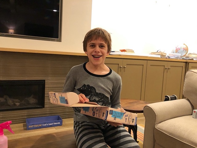 Owen with his gift, a knot making kit