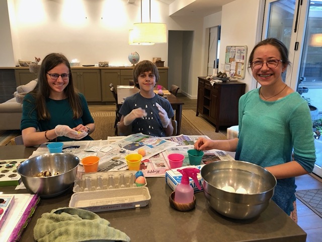 The kids all decorating eggs
