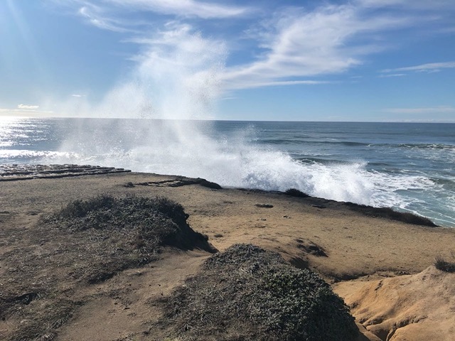Surf crashing over the top of the bluff